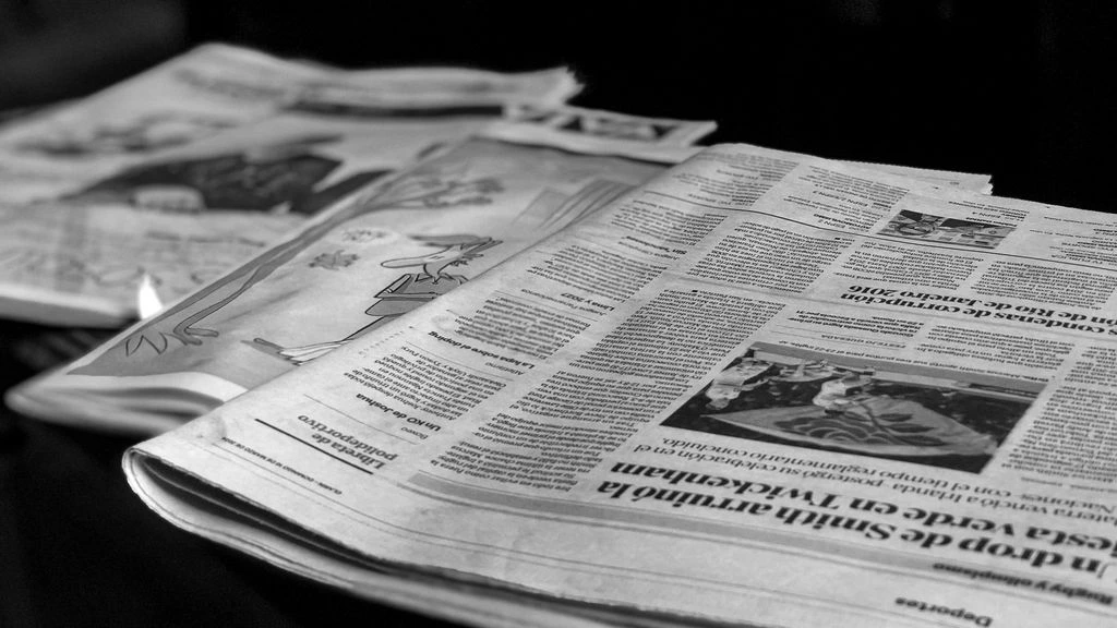 An executive briefing room at dawn with printed morning briefings on a polished table.